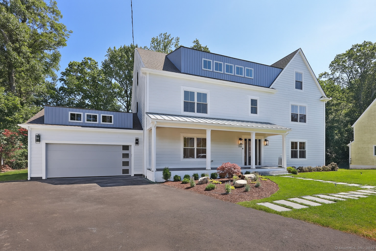 a front view of a house with yard and garage