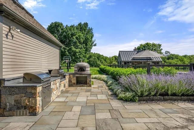 a view of a chairs and tables in the backyard of a house