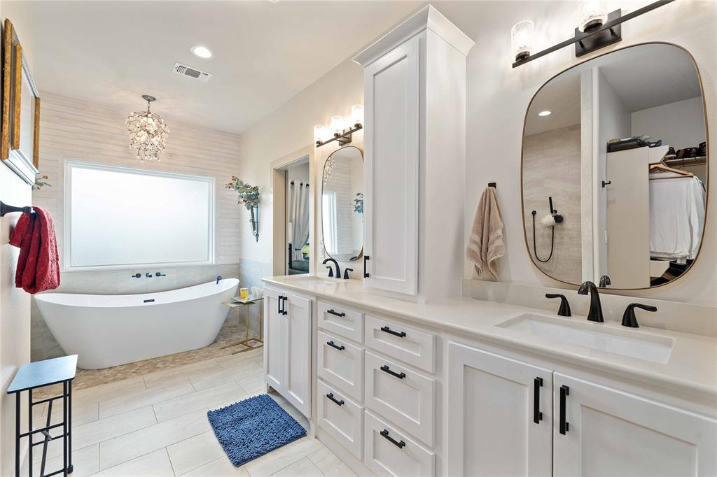 1010 Fm 583 Street West Rising Star, TX 76471 - Photo 26 of 40 a bathroom with a double vanity sink mirror bathtub and toilet