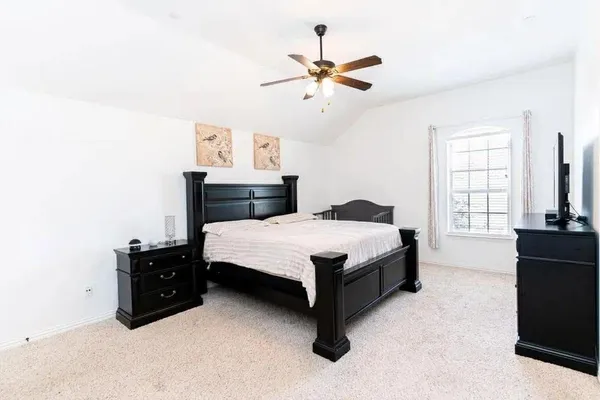 a bedroom with a bed and window
