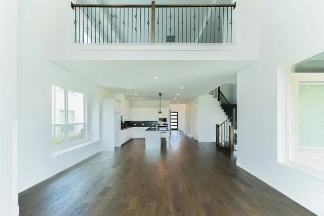 an empty room with wooden floor and a window