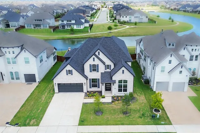 a aerial view of a house with a big yard and large trees