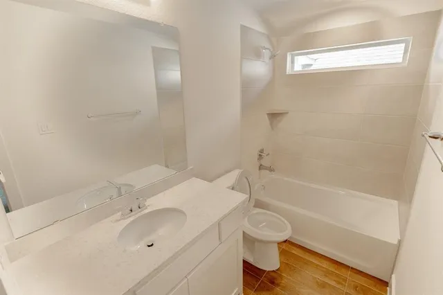 a bathroom with a sink toilet vanity and bathtub