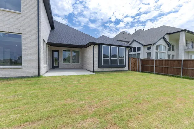 a view of a house with a backyard and balcony