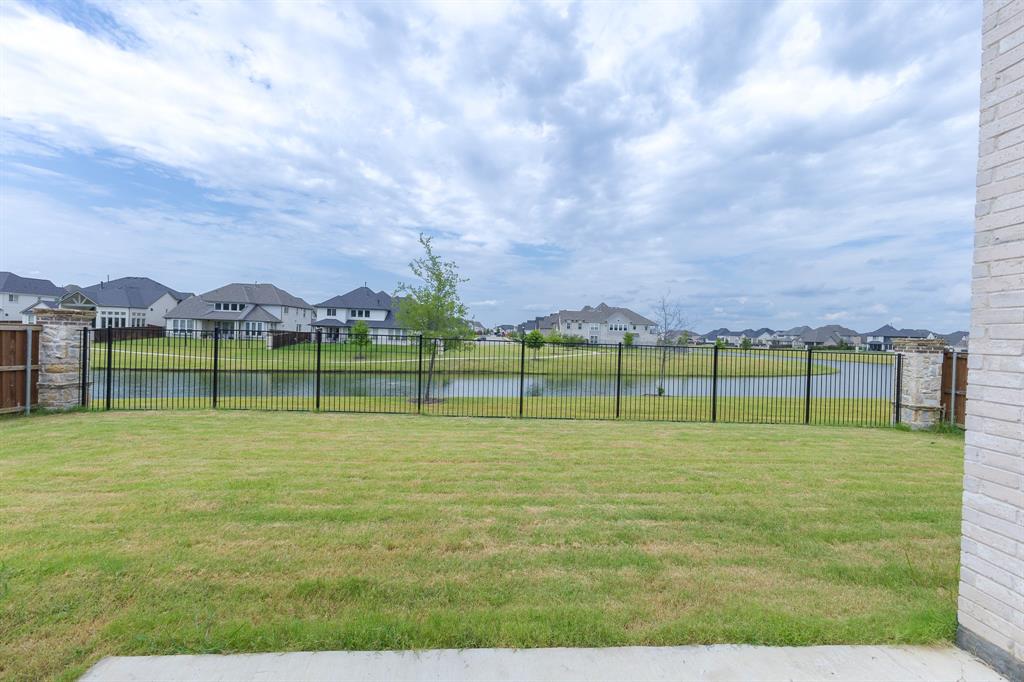 3020 Sunfish Street Prosper, TX 75078 - Photo 29 of 34 a view of a lake with houses in the background