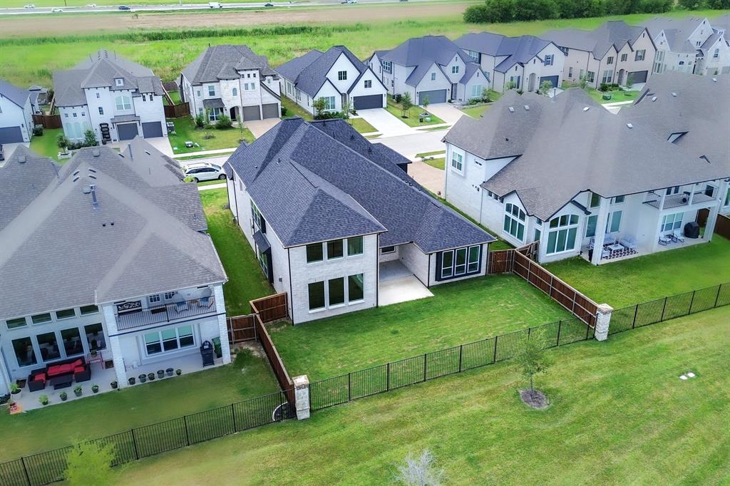 3020 Sunfish Street Prosper, TX 75078 - Photo 33 of 34 an aerial view of a house with swimming pool and a yard