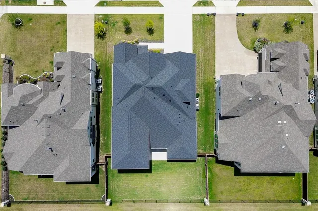 an aerial view of a house with a yard