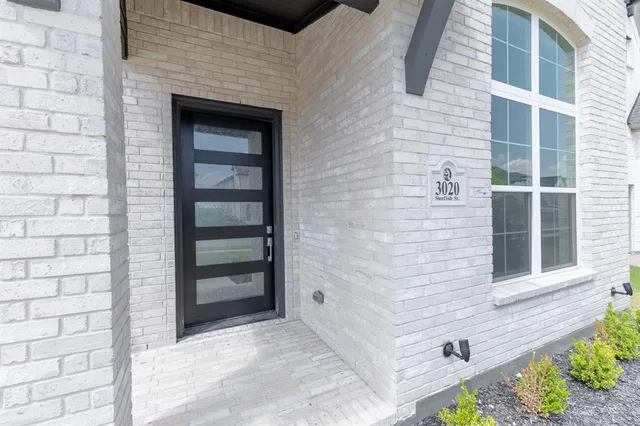 a view of a brick house with a large window