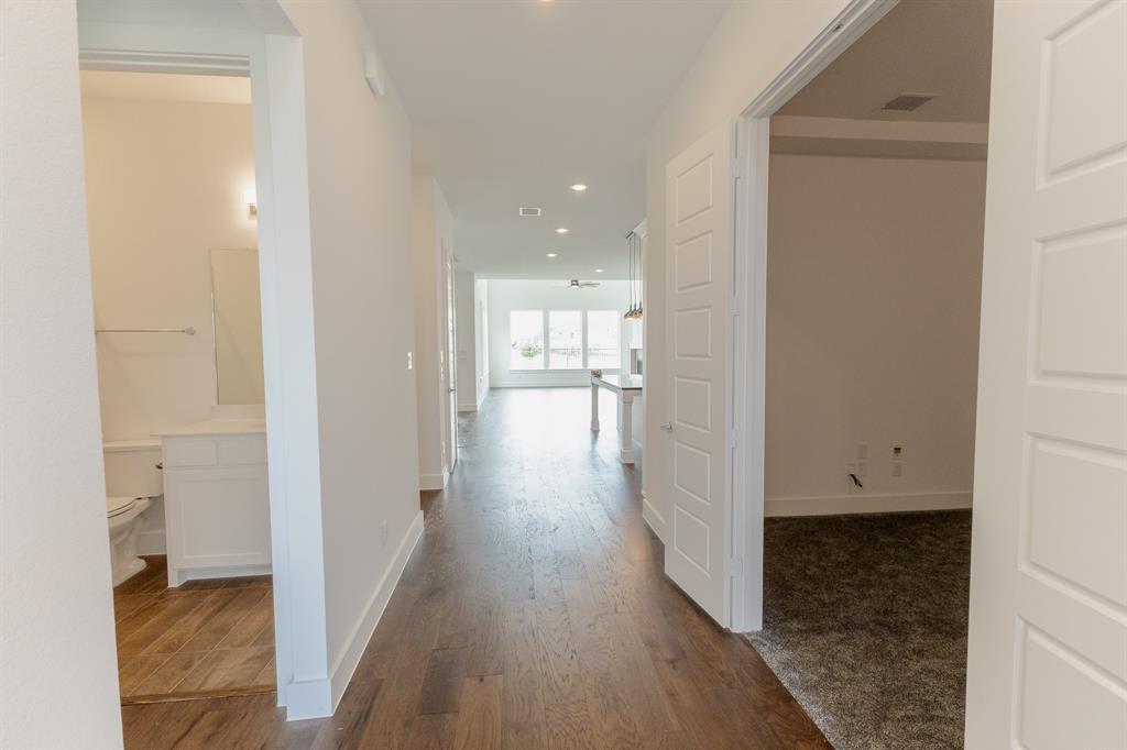 3020 Sunfish Street Prosper, TX 75078 - Photo 6 of 34 a view of a hallway with wooden floor