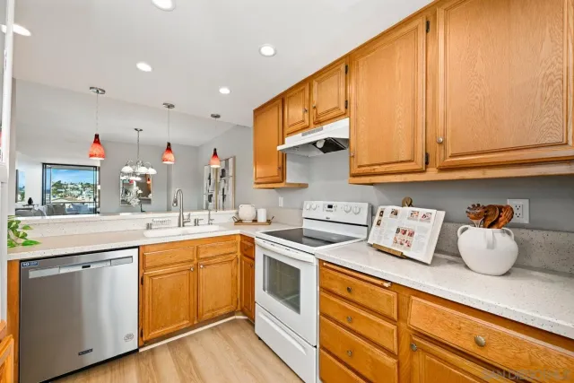 a kitchen with stainless steel appliances granite countertop a sink and cabinets