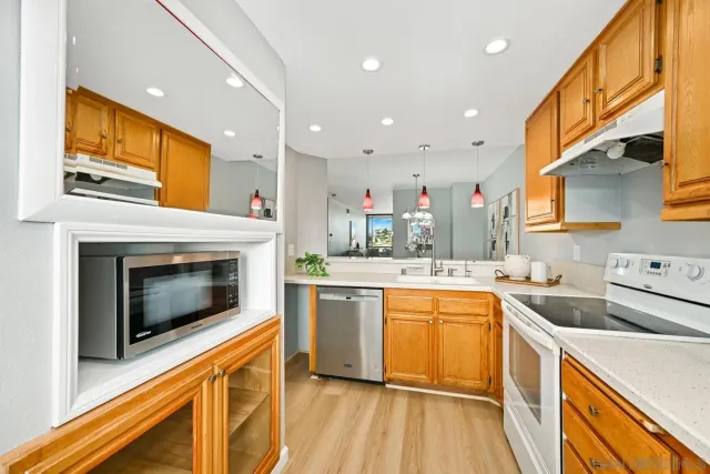 a kitchen with a sink a stove top oven and cabinets