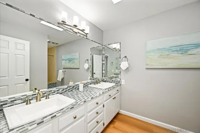 a bathroom with a sink vanity granite and a mirror