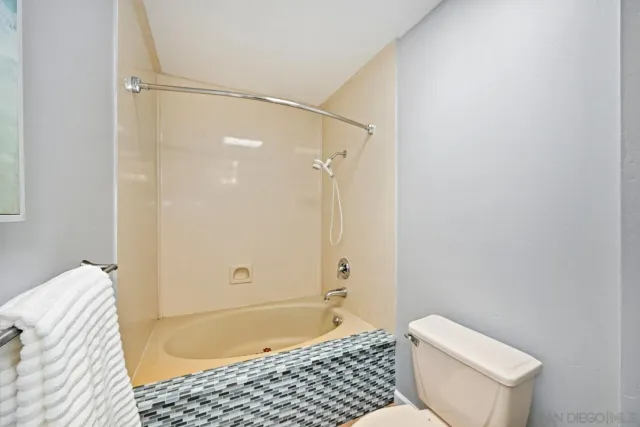 a bathroom with a bathtub and shower