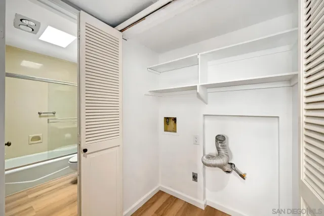 a bathroom with a window and a shower