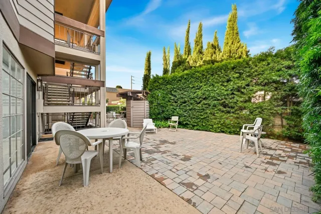 a view of a patio with table and chairs and potted plants