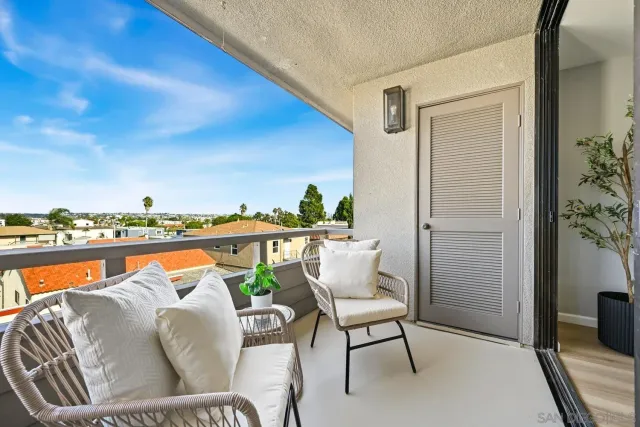 a balcony with furniture and outdoor view