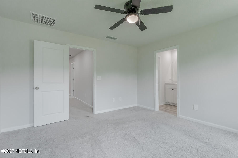 14438 Macadamia Lane Jacksonville, FL 32218 - Photo 16 of 32 an empty room with closet and a chandelier fan