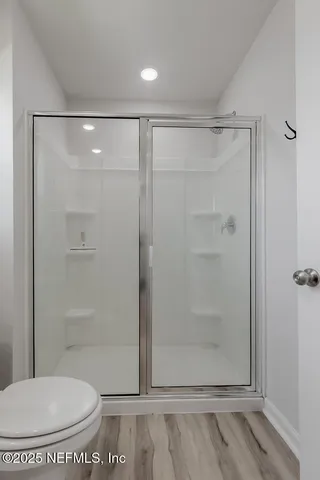 a bathroom with a shower and a toilet