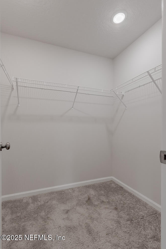 14438 Macadamia Lane Jacksonville, FL 32218 - Photo 19 of 32 a view of a room with racks on the wall