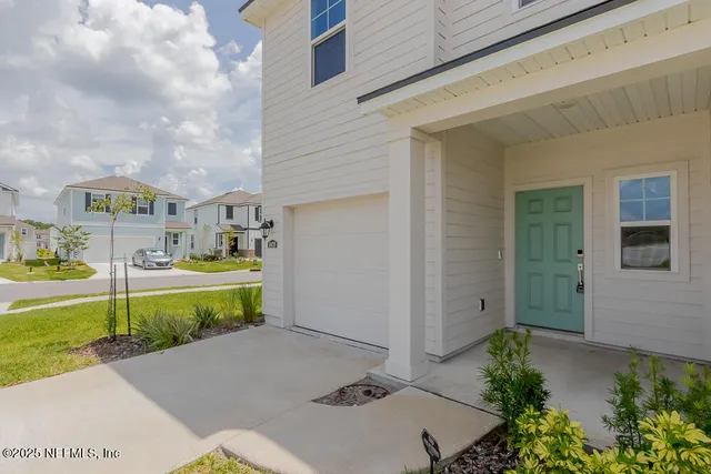 a view of house with outdoor space and tub