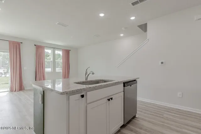 a kitchen with sink and window