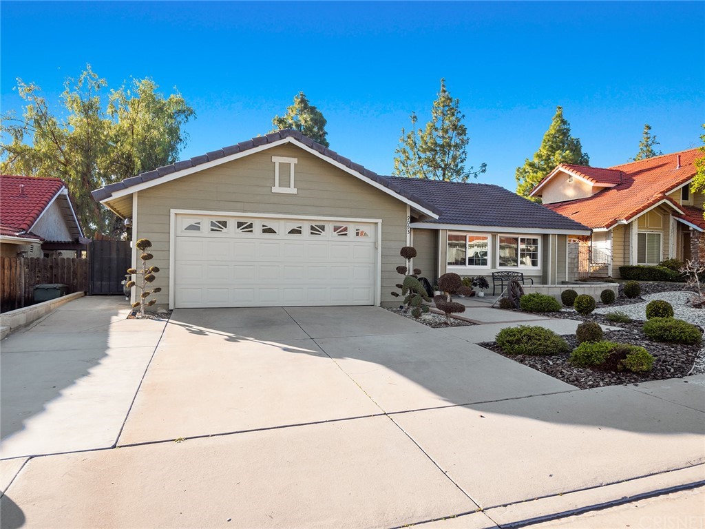 9093 Mandarin Lane Riverside, CA 92508 - Photo 1 of 1 a view of a white house with large windows and a small yard