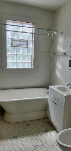 a bathroom with a bathtub and a window