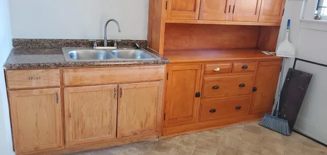 a kitchen with cabinets and a sink