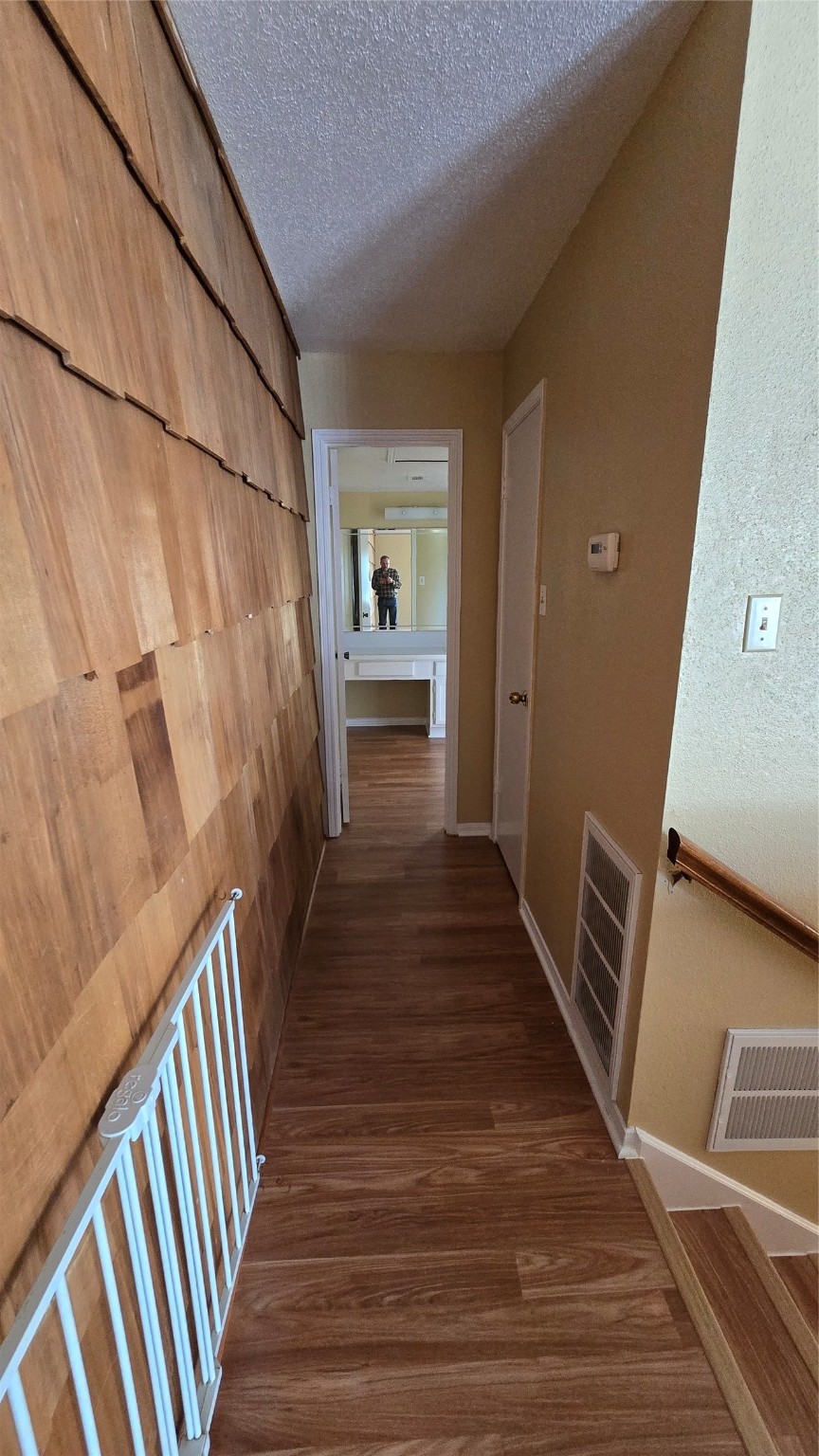 135 April Point Drive North Conroe, TX 77356 - Photo 14 of 28 a view of a hallway to a livingroom with wooden floor and stairs