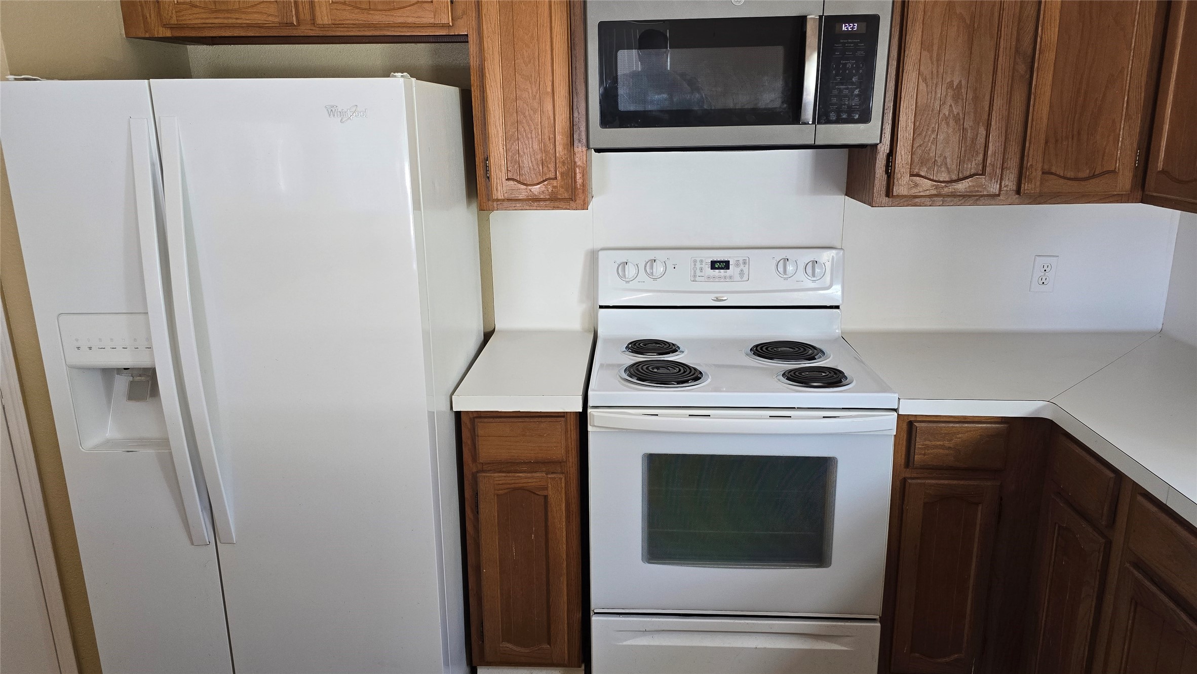 135 April Point Drive North Conroe, TX 77356 - Photo 23 of 28 a kitchen with a stove and white cabinets