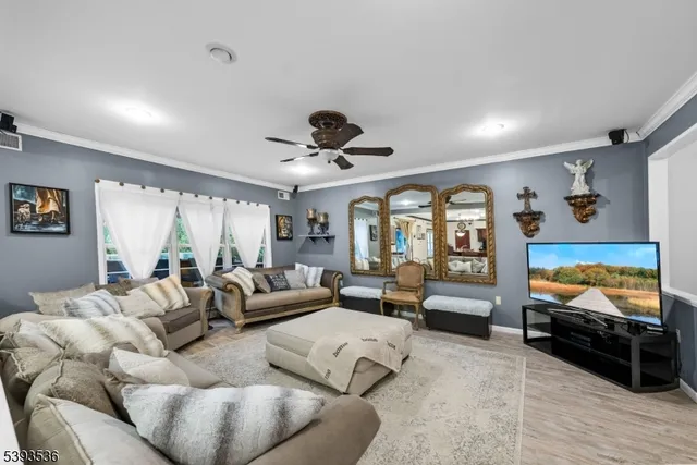 a dining area with stainless steel appliances granite countertop a sink a stove a dining table and chairs with wooden floor