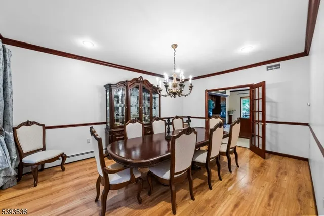 a kitchen with stainless steel appliances granite countertop a sink a stove and chairs