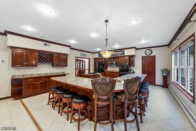 a kitchen with stainless steel appliances granite countertop a stove refrigerator and a stove