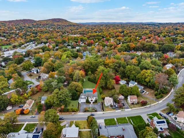 an aerial view of a houses with yard