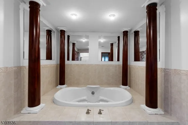 a spacious bedroom with a bed and a chandelier