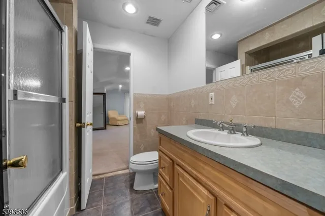 a bedroom with bed couch and window