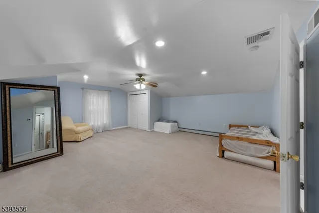 a living room with furniture a air conditioner vent and a window