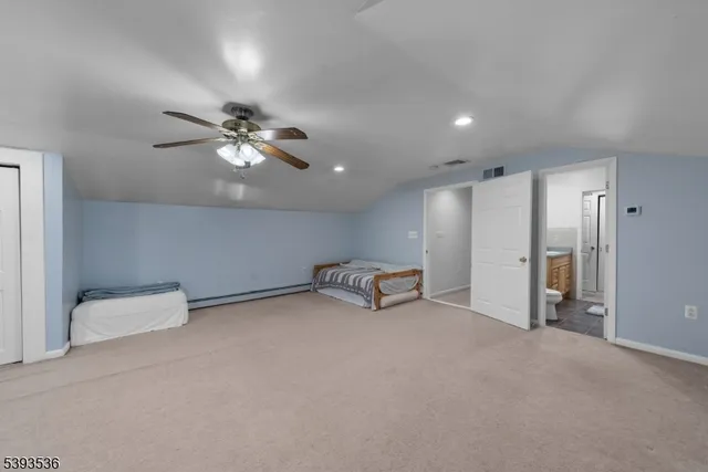 a living room with furniture a flat screen tv and a couch