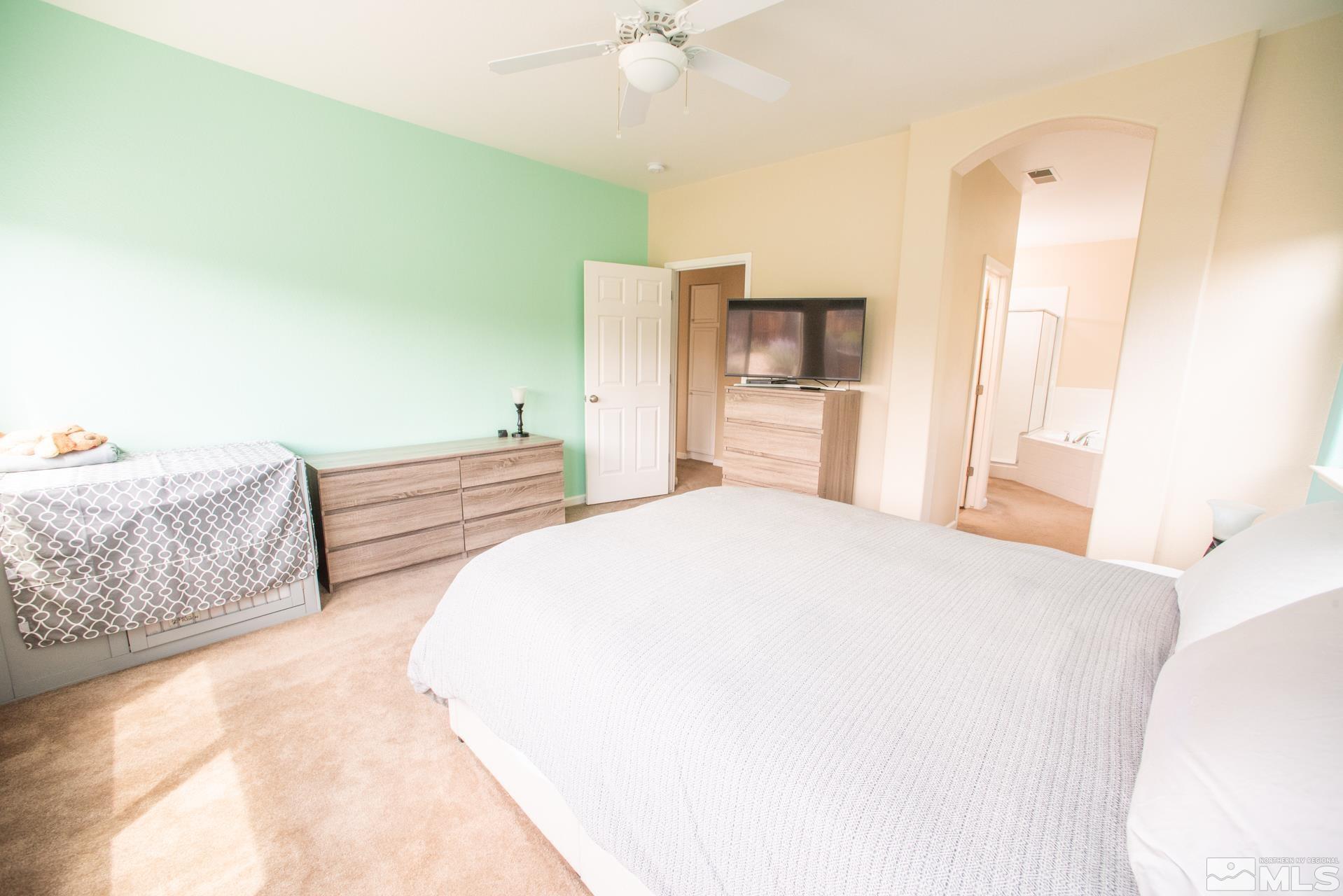 1798 Ornellaia Way Reno, NV 89521 - Photo 12 of 24 a bedroom with a bed and a chandelier