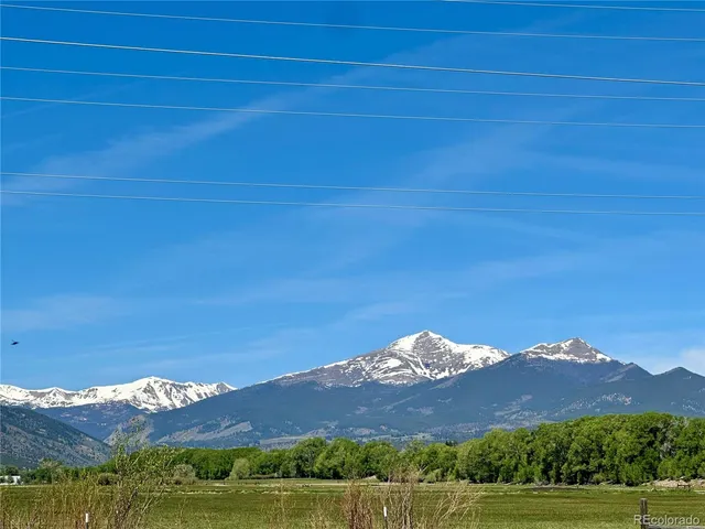 a view of a large mountain with a mountain in the background