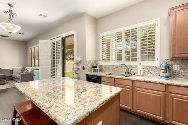 a kitchen with granite countertop sink and cabinets