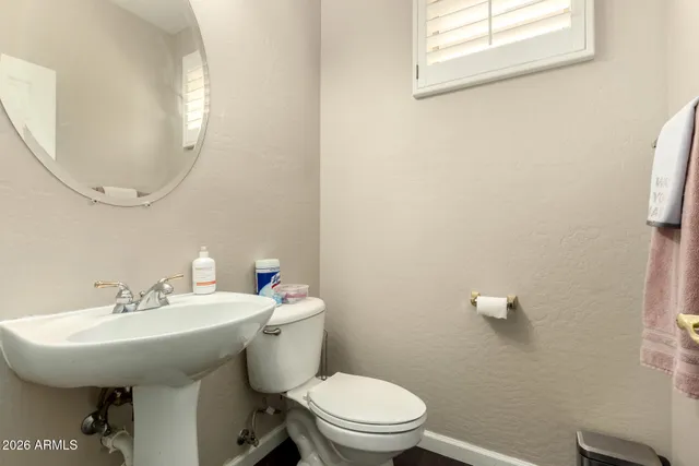a bathroom with a sink a mirror and a toilet