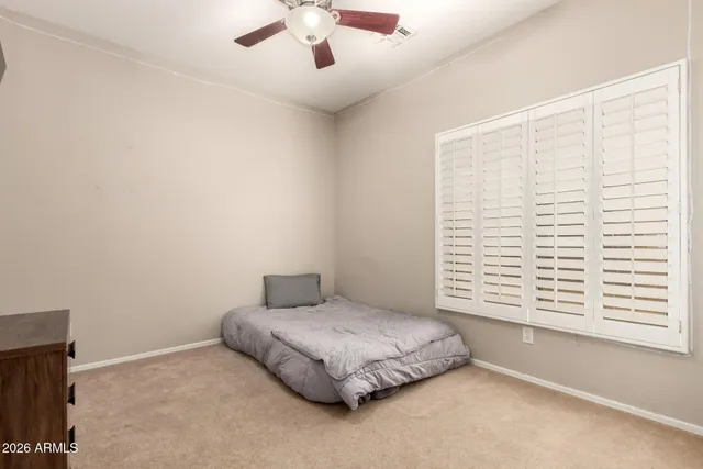 a spacious bedroom with a bed and a window