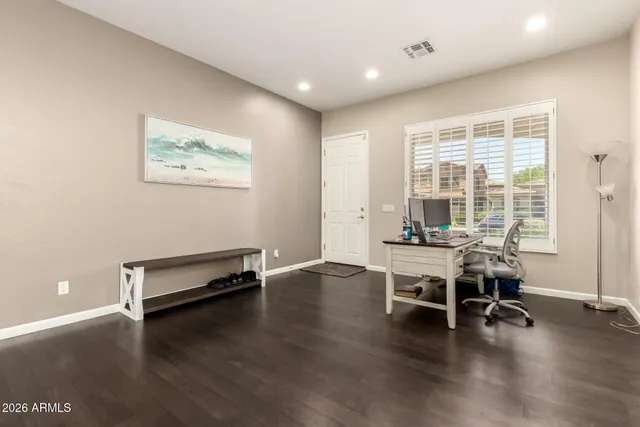 a view of a workspace with furniture and wooden floor