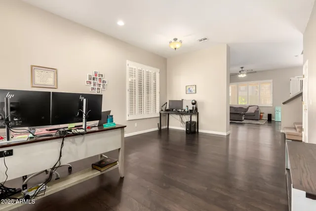 a view of a livingroom with workspace and a flat screen tv