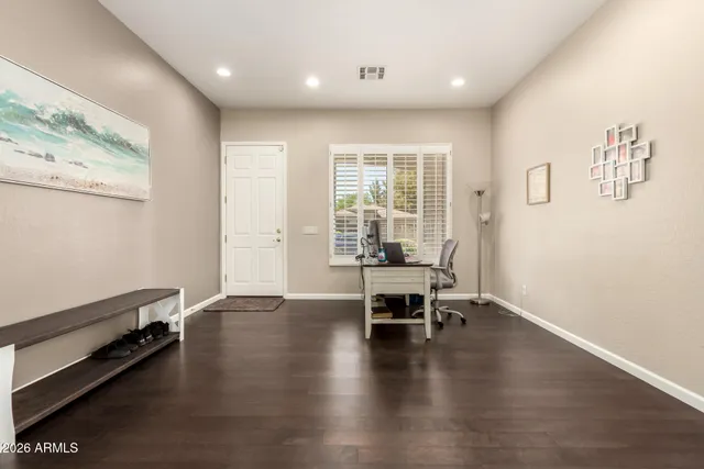 an empty room with wooden floor and a window