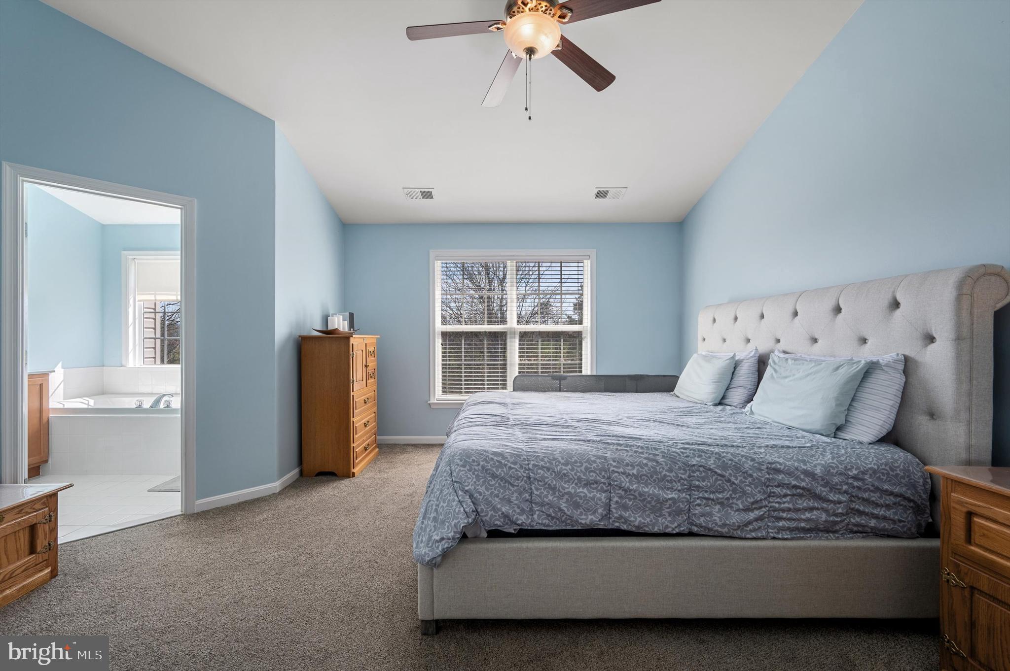 15 Driver Square Front Royal, VA 22630 - Photo 17 of 45 a spacious bedroom with a large bed and a chandelier
