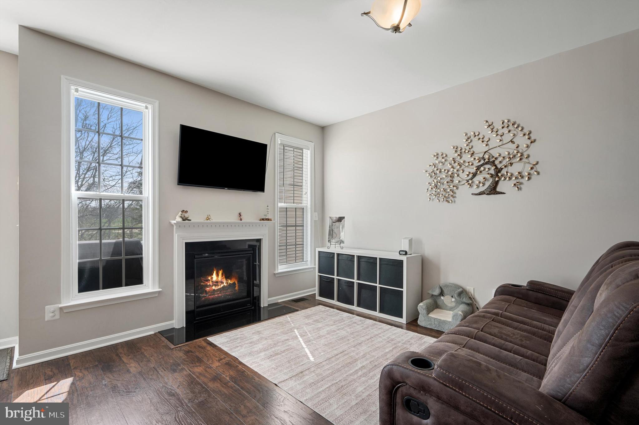 15 Driver Square Front Royal, VA 22630 - Photo 7 of 45 a living room with furniture a flat screen tv and a fireplace