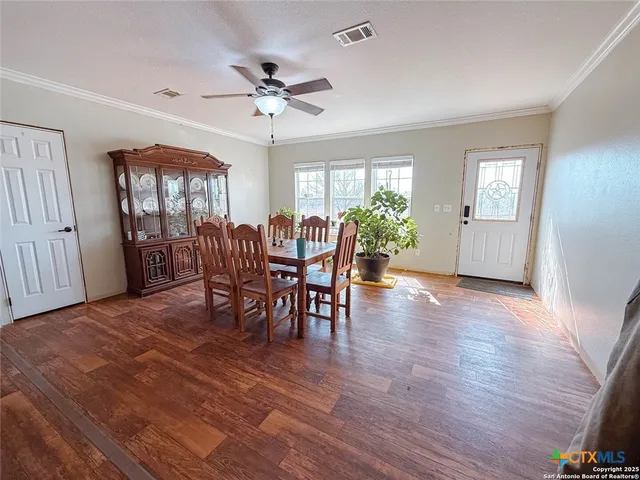 a view of a dining room with furniture window and wooden floor