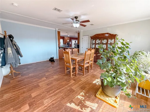 a dining room with furniture entryway and wooden floor